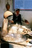 During the first half of the 1st century CE, silk worm technology is thought to have reached the Han-Chinese dominated oasis of Khotan in the Tarim Basin – an oasis that is still a centre of silk production today. A Chinese princess given in marriage to a Khotan prince is said to have carried the eggs of silkworms to her new husband concealed in her hair.<br/><br/>It is thought that silkworms and knowledge of sericulture travelled from Khotan south to India and west to Sassanid Persia during the 4th century, while records also recount a Japanese expedition to China in the same century carrying four silk-weaving girls, together with silkworm eggs, back to Japan.<br/><br/>Khotan traces its history back at least as far as the 3rd century BCE, when the eldest son of the Indian emperor Asoka is said to have settled here. It was of great importance on the Silk Road, and is claimed to have been the first place outside China to have cultivated silk.<br/><br/>It sits astride the Karakash or ‘Black Jade’ and Yurungkash or ‘White Jade’ Rivers, which here conjoin to form the Khotan Darya, and has been famous for its jade for well over two millennia.<br/><br/>In times past trade routes crossed the desert to the north all the way to Kuqa, and as recently as 2007 this link has been re-established for the first time in centuries with the opening of a second Desert Highway leading to Aksu, distant some 424km to the north.<br/><br/>In 1006 Khotan was conquered by Uighur Muslims from Kashgar, and since that time the city remains a very Uighur place.